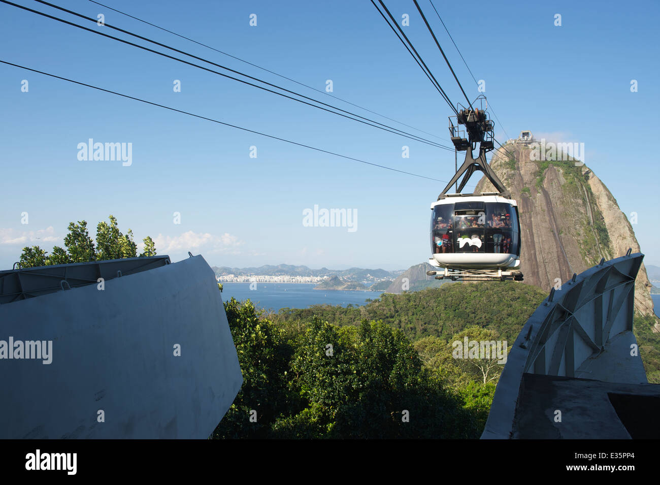 RIO DE JANEIRO, BRAZIL - OCTOBER 20, 2013: Cable car full of tourists arrives at the station on Sugarloaf Mountain. Stock Photo