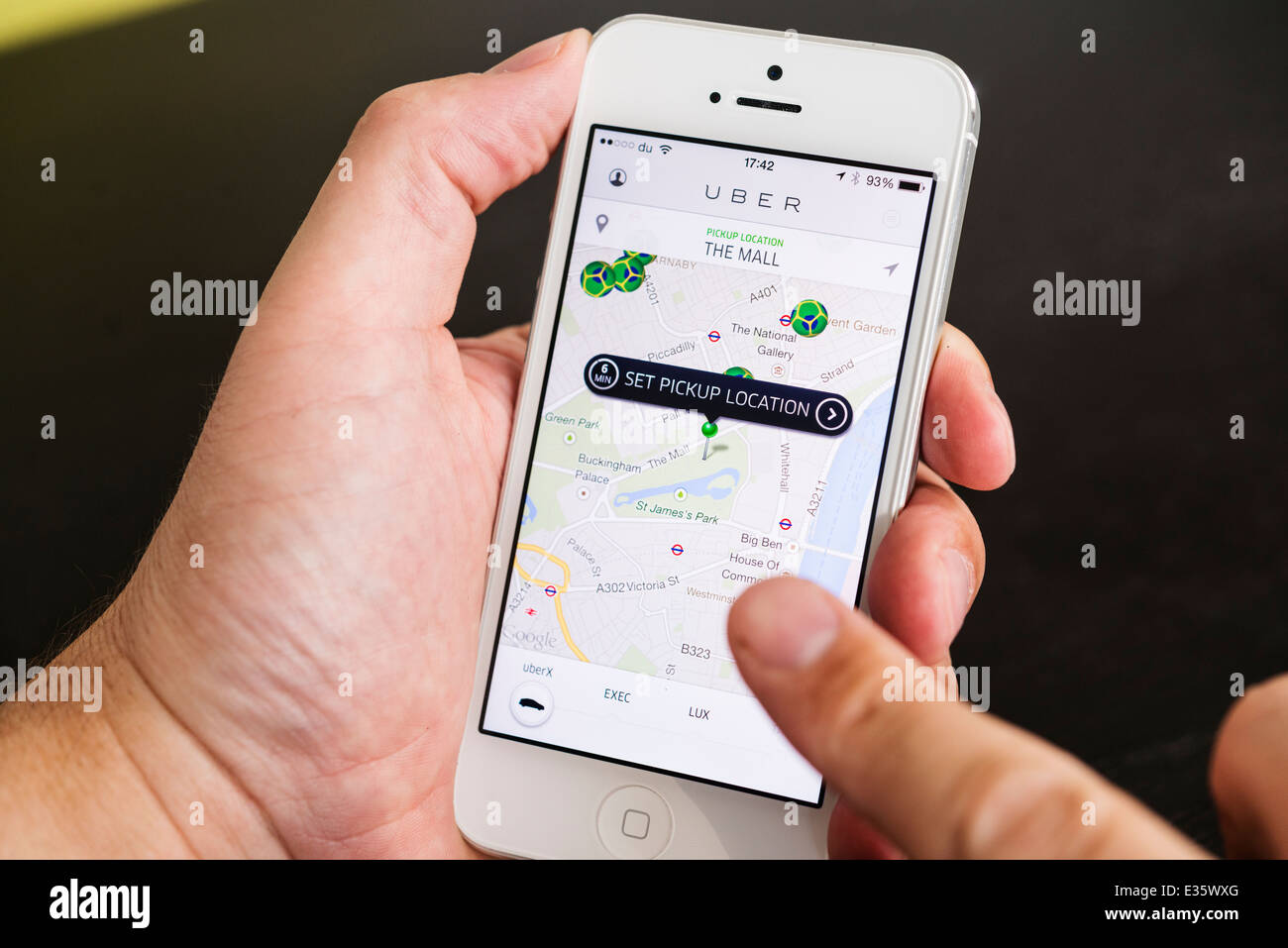 Detail of Uber taxi booking app showing pick-up points in London on iphone smart phone Stock Photo