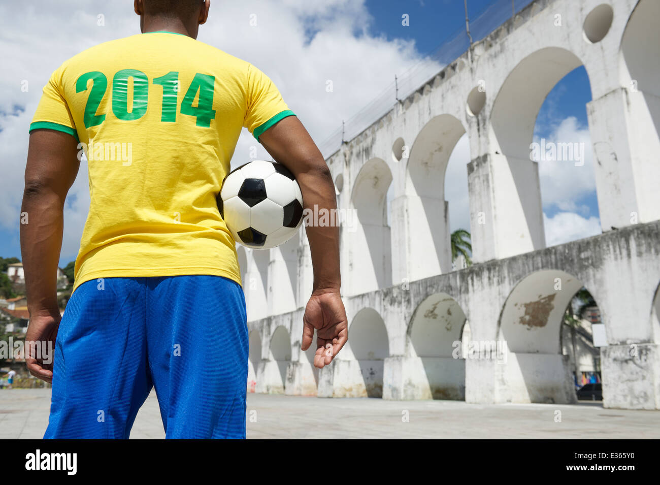 Brazil 2014 footballer soccer player holding football in Brazil colors Rio de Janeiro Stock Photo