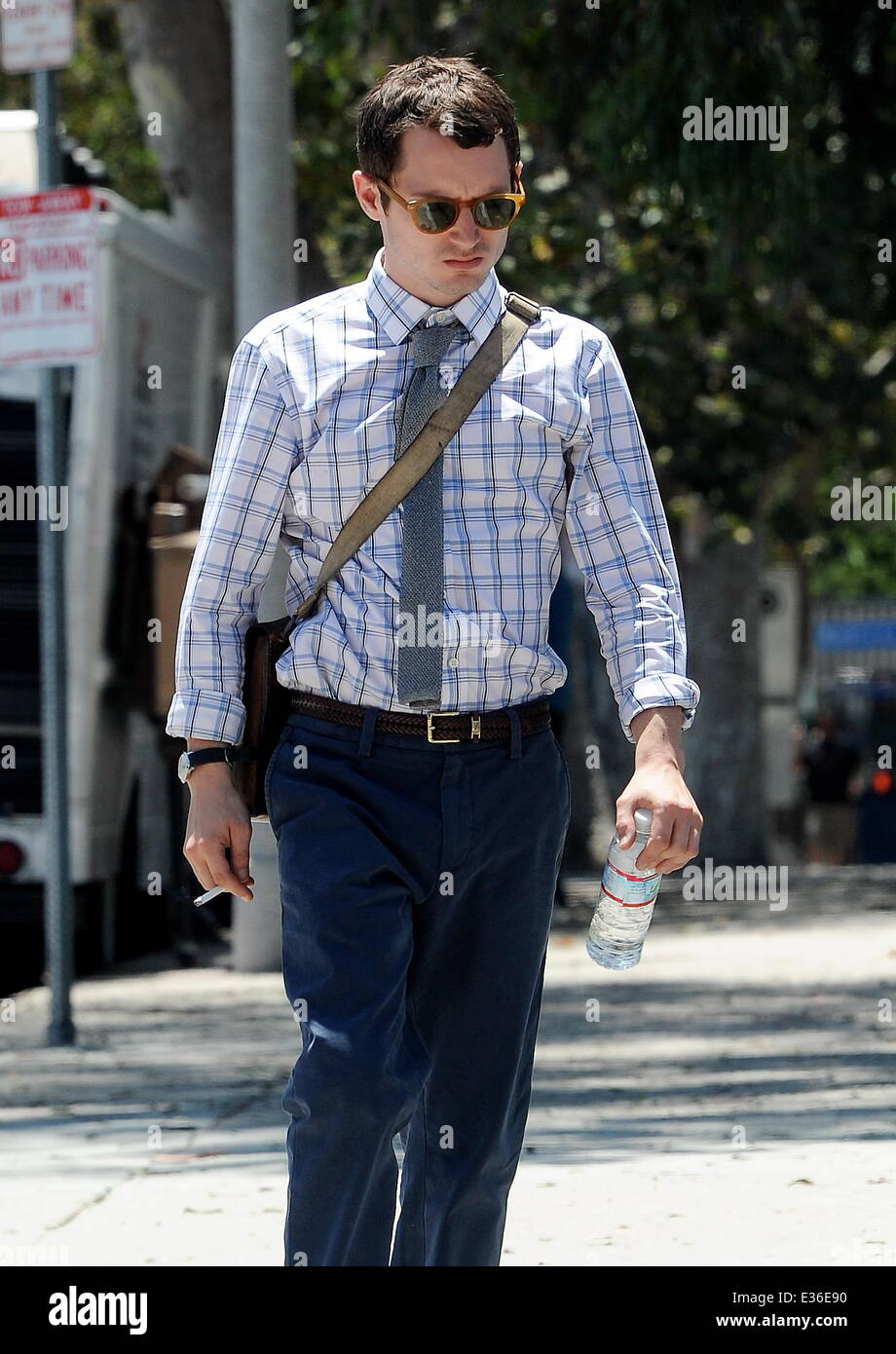 Elijah Wood sparks up a cigarette during a lunch break on his new horror-comedy movie 