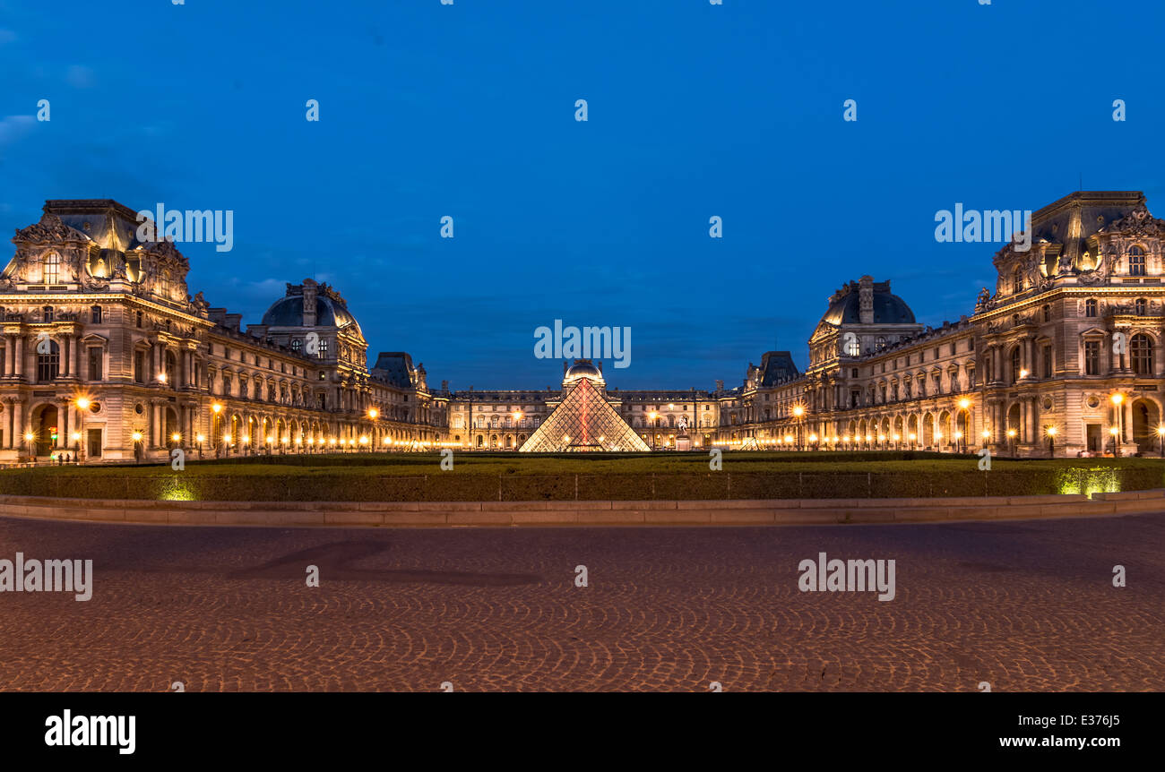 The Louvre, Paris, at twilight, one of the major tourist attractions in France and in Europe Stock Photo