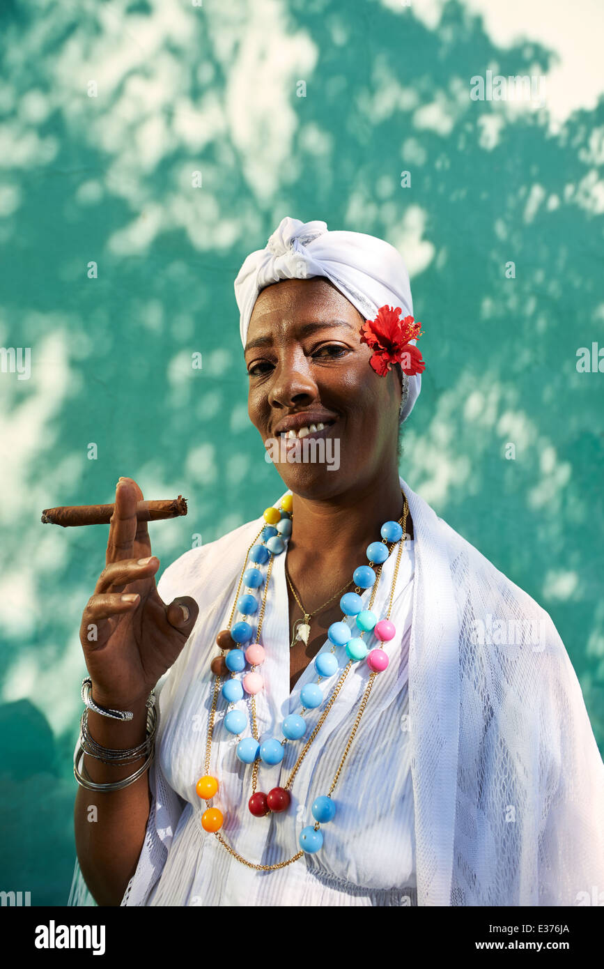 Portrait of african cuban woman smoking cohiba cigar and looking at camera smiling Stock Photo