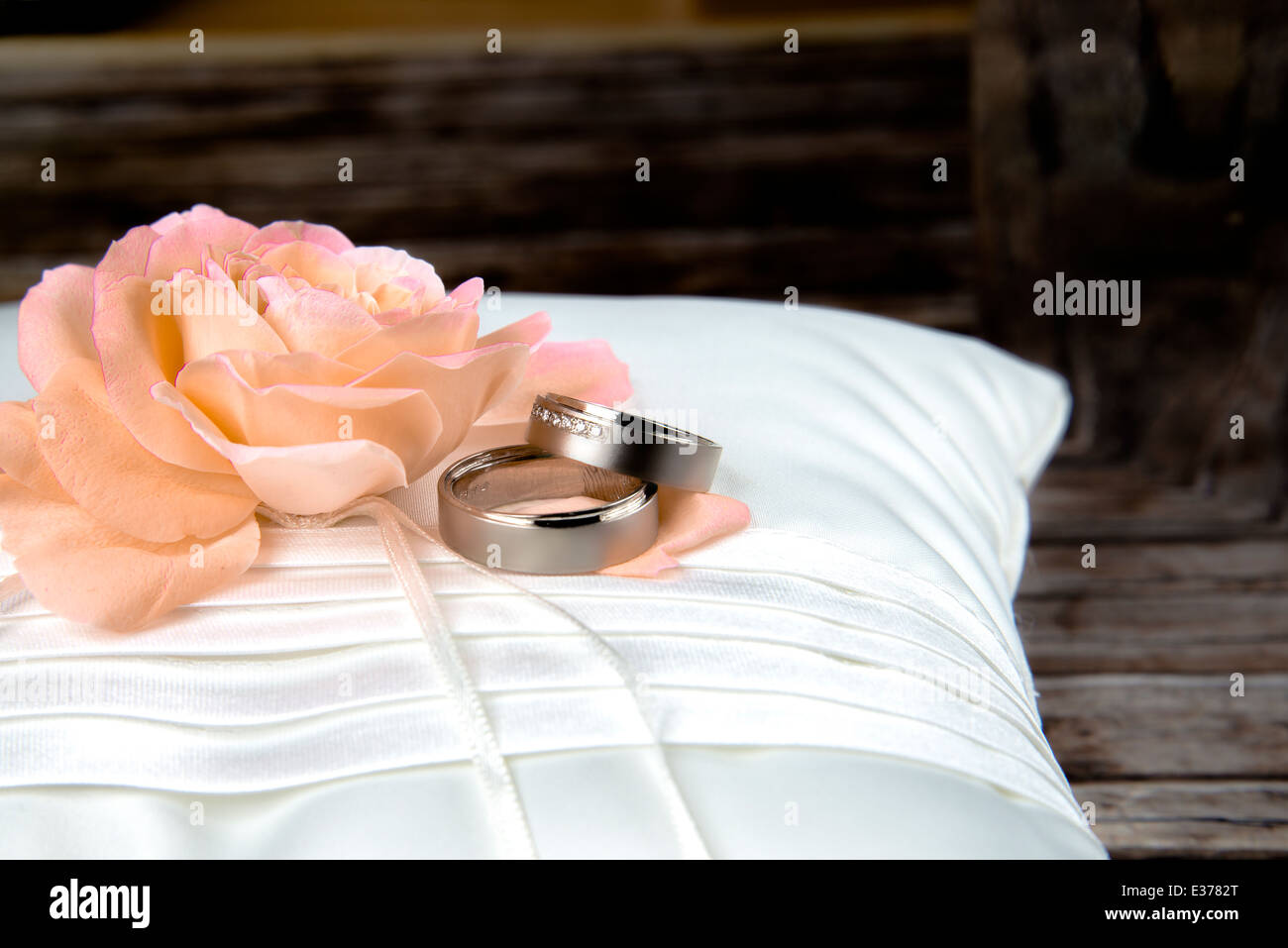 wedding rings on pillow with roses Stock Photo