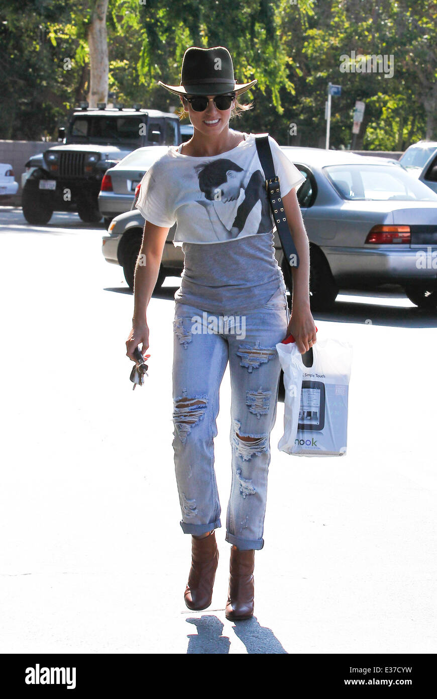 Nikki Reed wearing ripped jeans and an Indiana Jones explorer hat