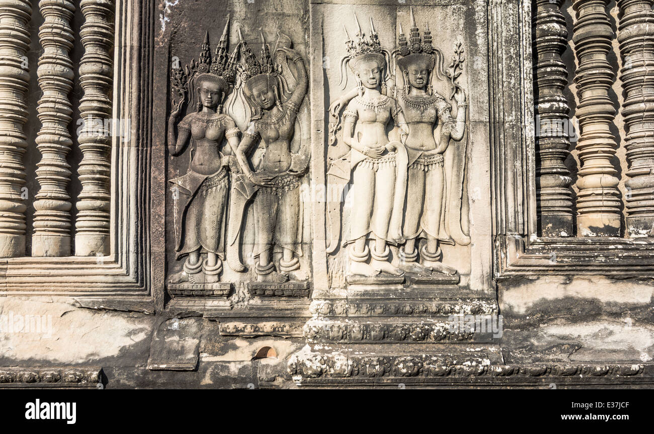 Bas-relief of an Aspara dancer next to an warrior at the ancient temple of Angkor Wat, Cambodia. Stock Photo