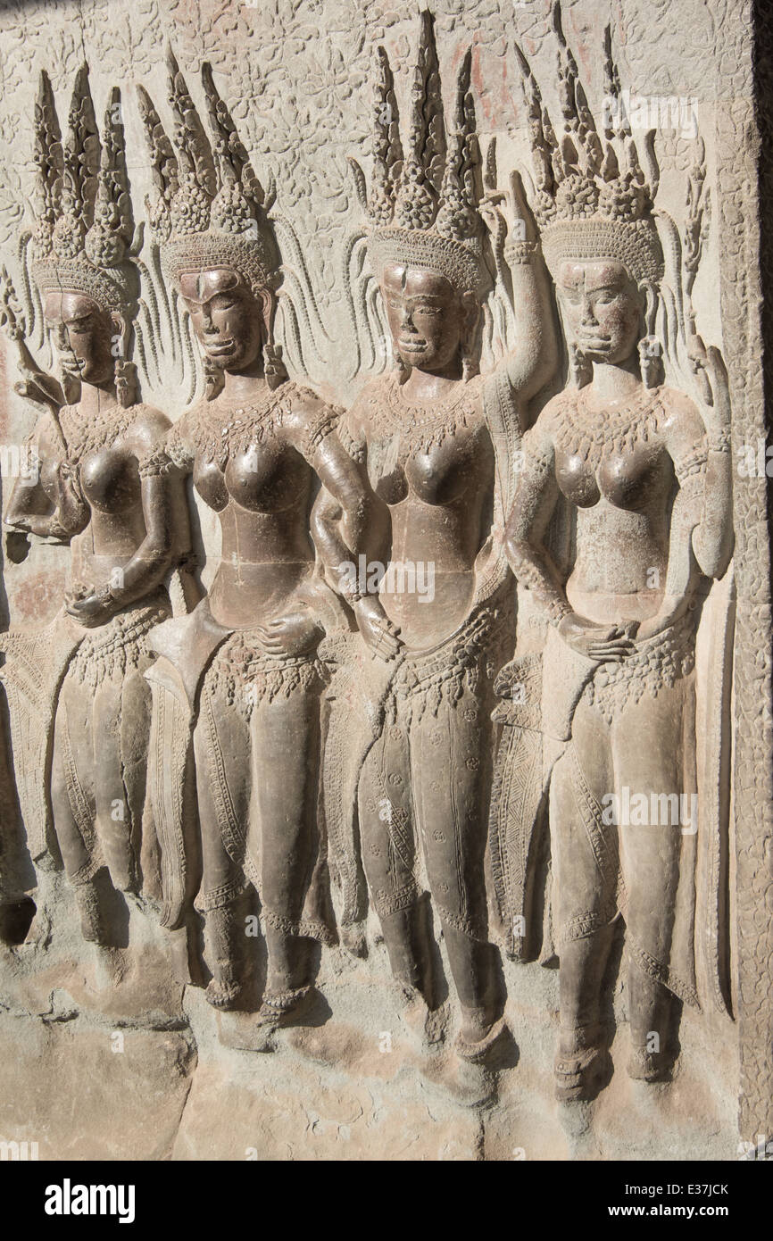 Bas-relief of an Aspara dancer next to an warrior at the ancient temple of Angkor Wat, Cambodia. Stock Photo
