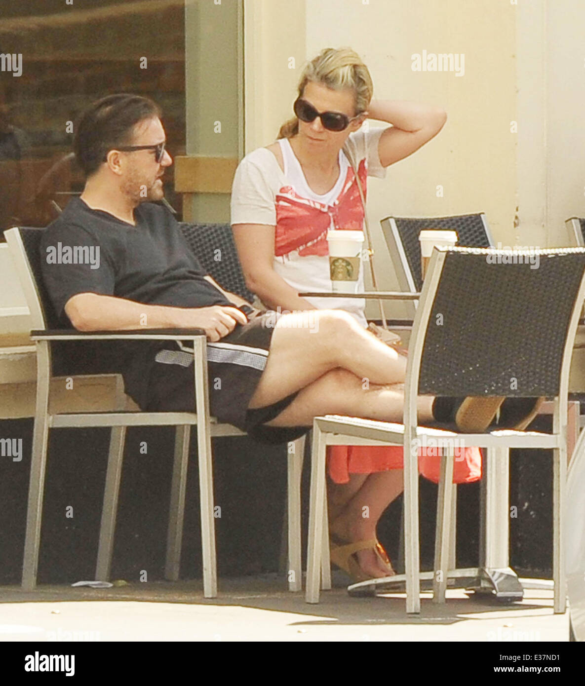 Comedian Ricky Gervais and his partner Jane Fallon relax outside