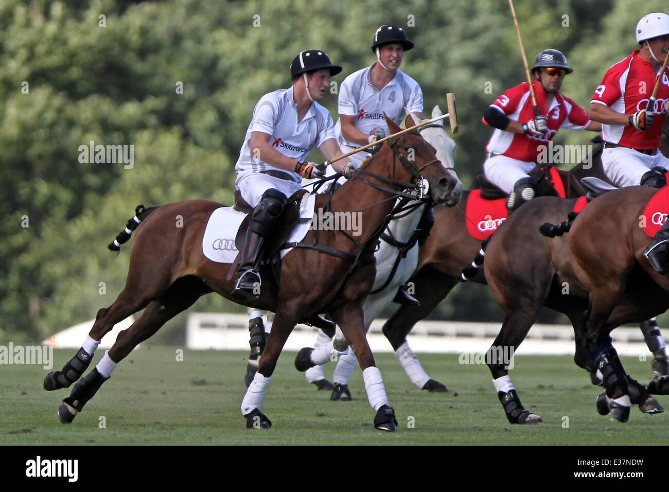 Prince William and Prince Harry play polo at the Audi Polo day at Coworth Park.  Featuring: Prince Harry,Prince William Where: L Stock Photo