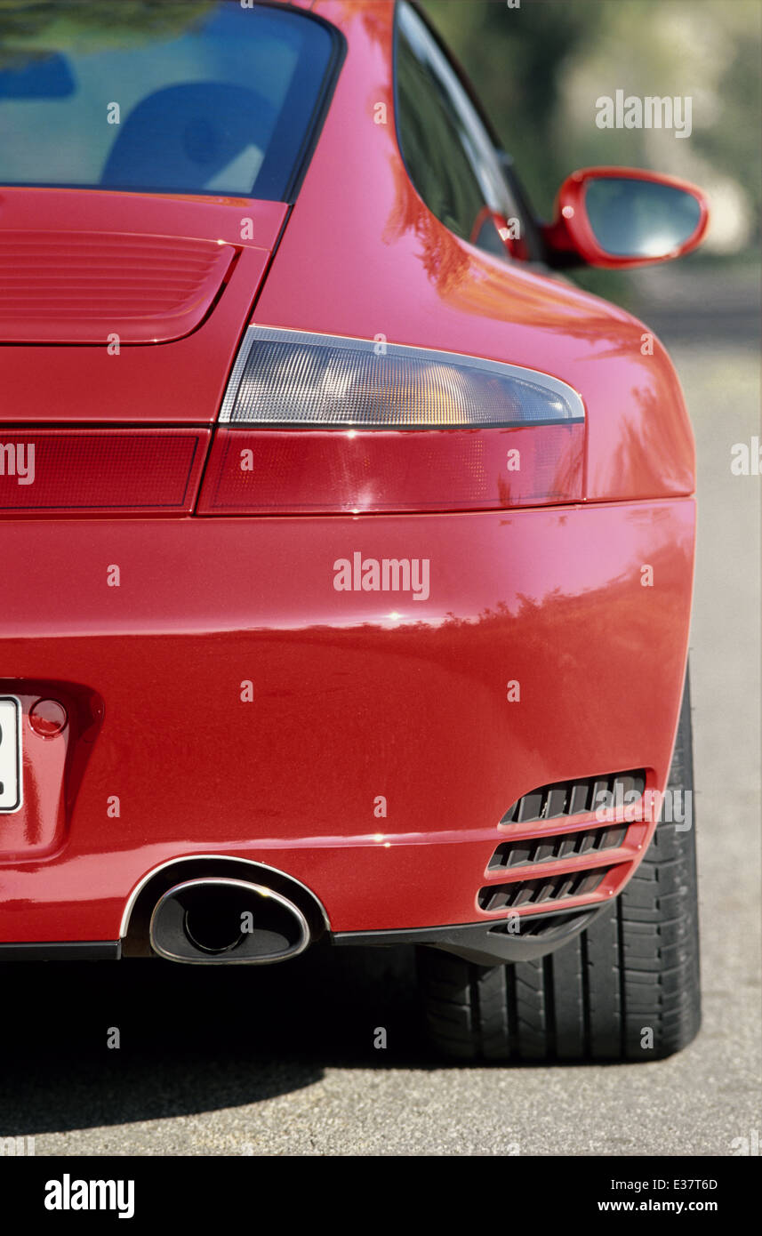 Porsche 911 Carrera 4S - 996 Model - 2001 in red - rear quarter view  showing exhaust pipe and wide tyres Stock Photo - Alamy