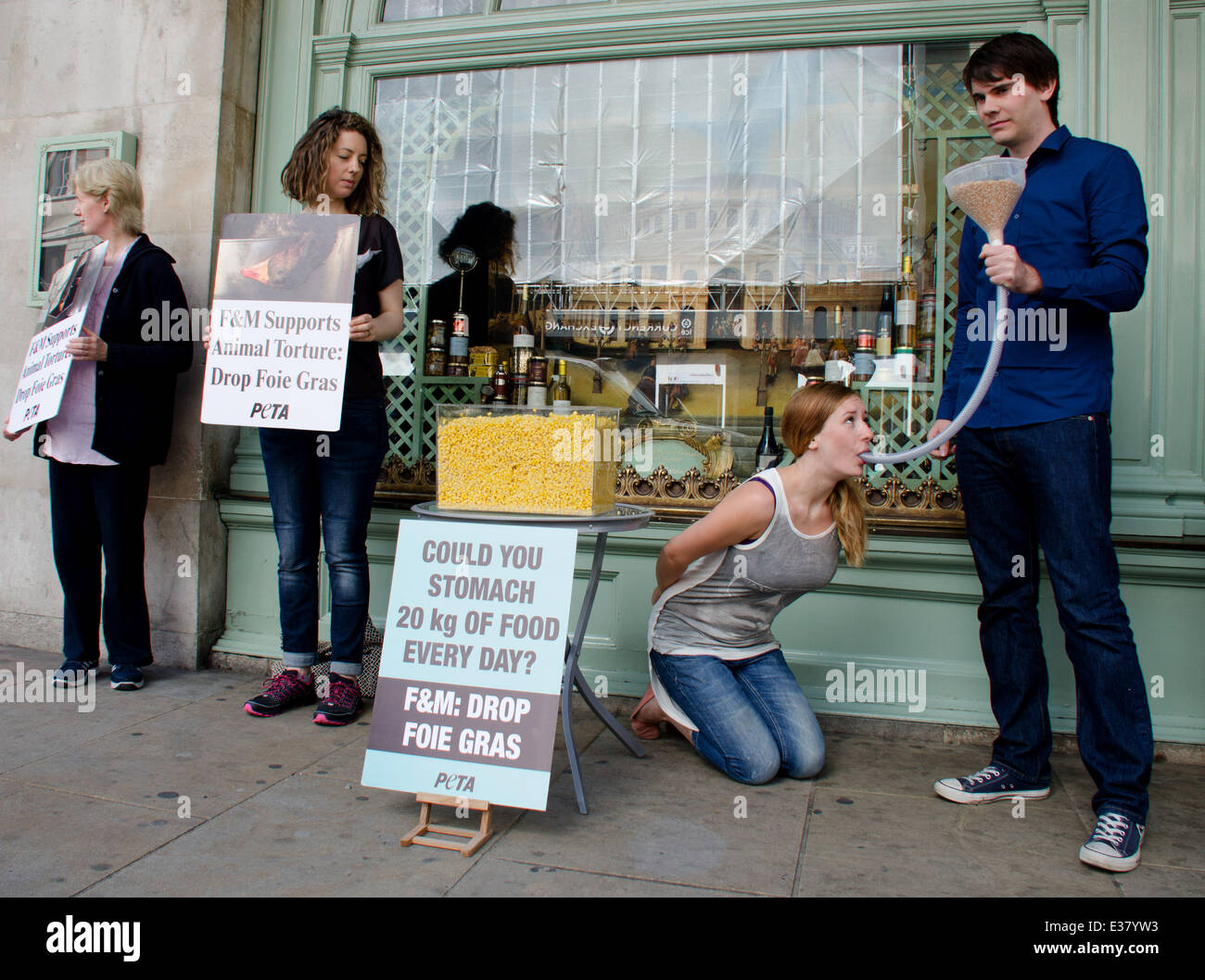 A PETA member is "force-fed" through a tube outside Fortnum & Mason in  Piccadilly, London, to illustrate the human equivalent of what geese raised  and killed for foie gras are forced to