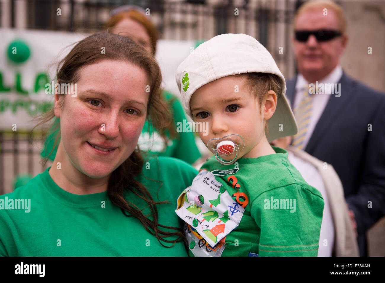 Belfast City Hall,UK. 22nd June 2014. A Macmillan Supporter with her Son Sam at the 6 Marathons in 6 Countries in 6 Days finish line in Belfast Stock Photo