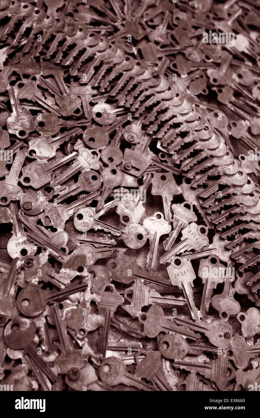 Close up of keys piles with shallow depth of field. Dramatic image with patterns. Golden toned vertical photograph Stock Photo