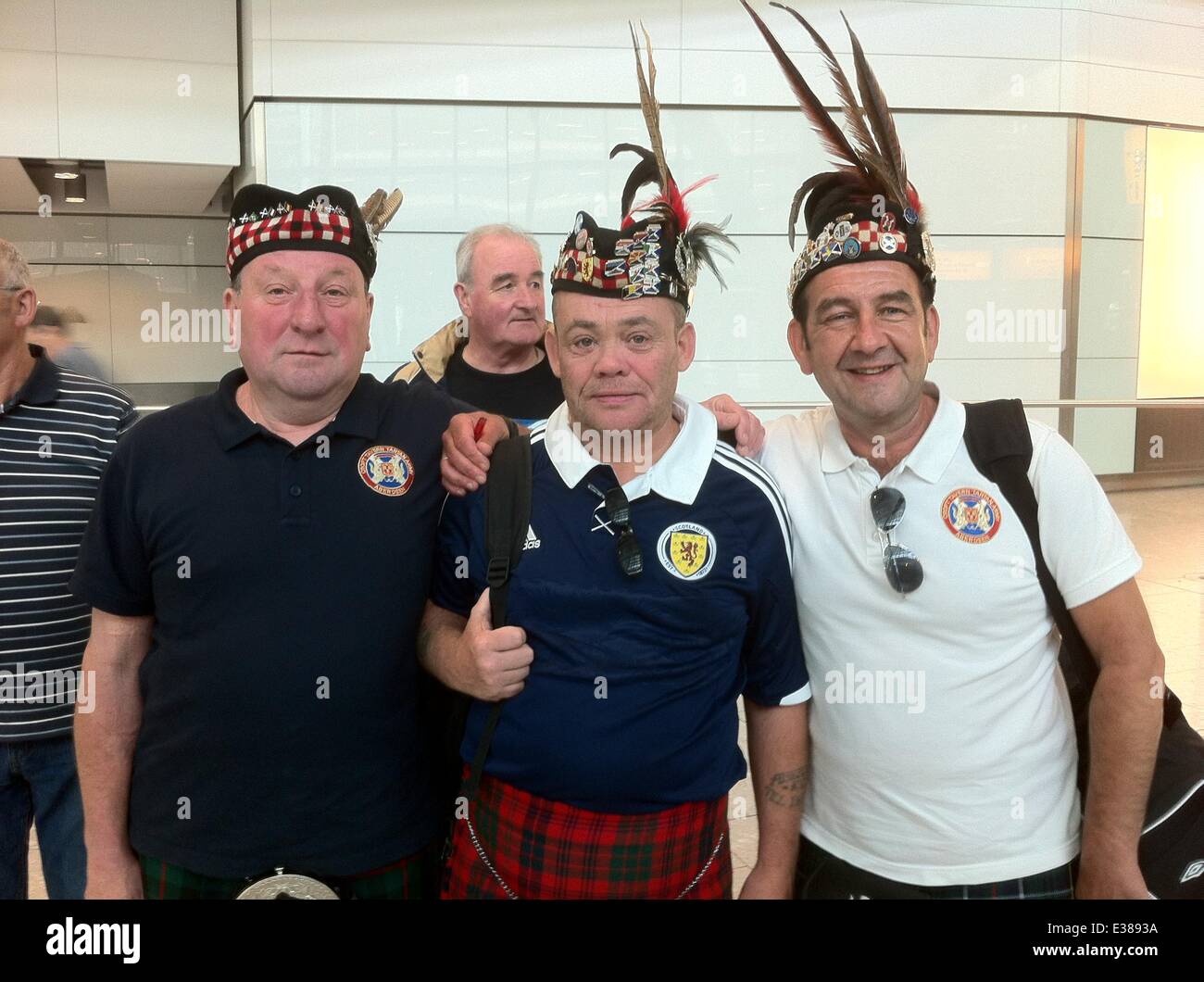Scottish football fans known as the Tartan Army arrive at Heathrow airport before the match between England and Scotland.  Featuring: Atmosphere Where: London, United Kingdom When: 13 Aug 2013 Stock Photo
