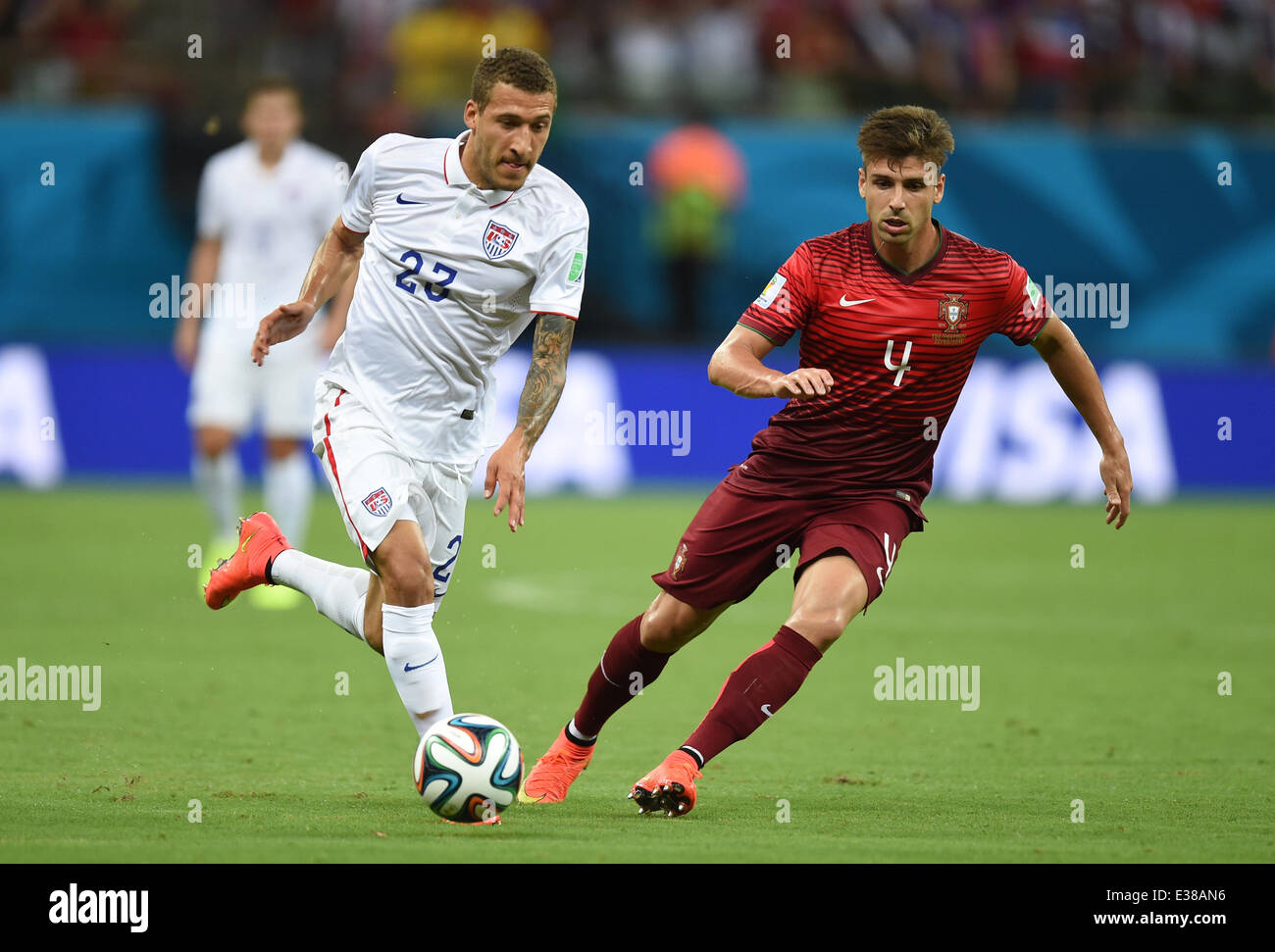 Manaus, Brazil. 22nd June, 2014. Fabian Johnson (L) of USA in action against Miguel Veloso of Portugal during the FIFA World Cup 2014 group G preliminary round match between the USA and Portugal at the Arena Amazonia Stadium in Manaus, Brazil, 22 June 2014. Photo: Marius Becker/dpa/Alamy Live News Stock Photo