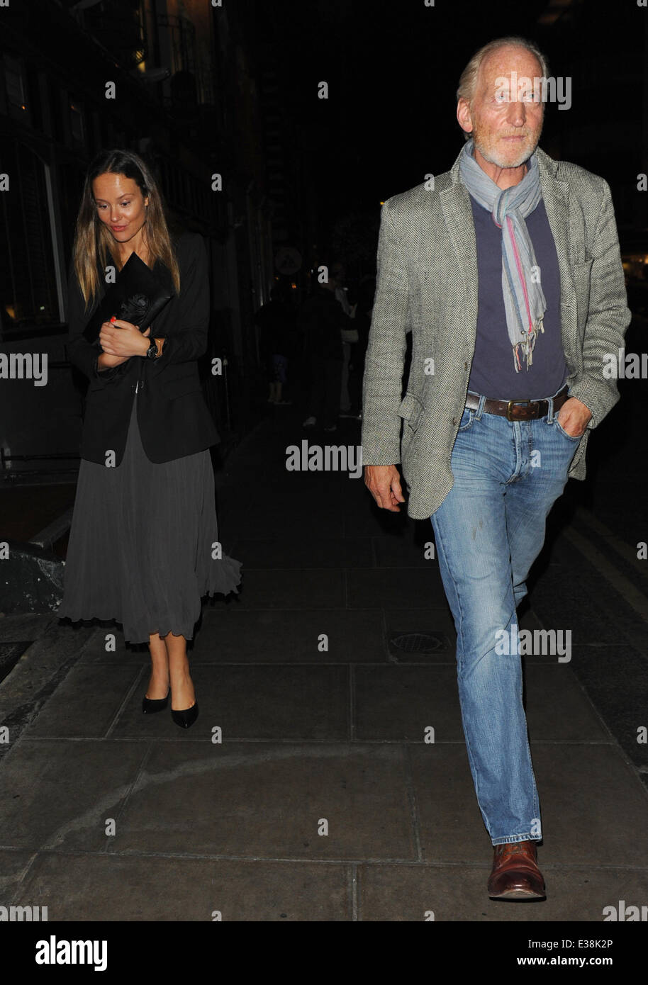 Charles Dance leaves The Groucho Club with a woman  Featuring: Charles Dance Where: London, United Kingdom When: 17 Aug 2013 Cre Stock Photo