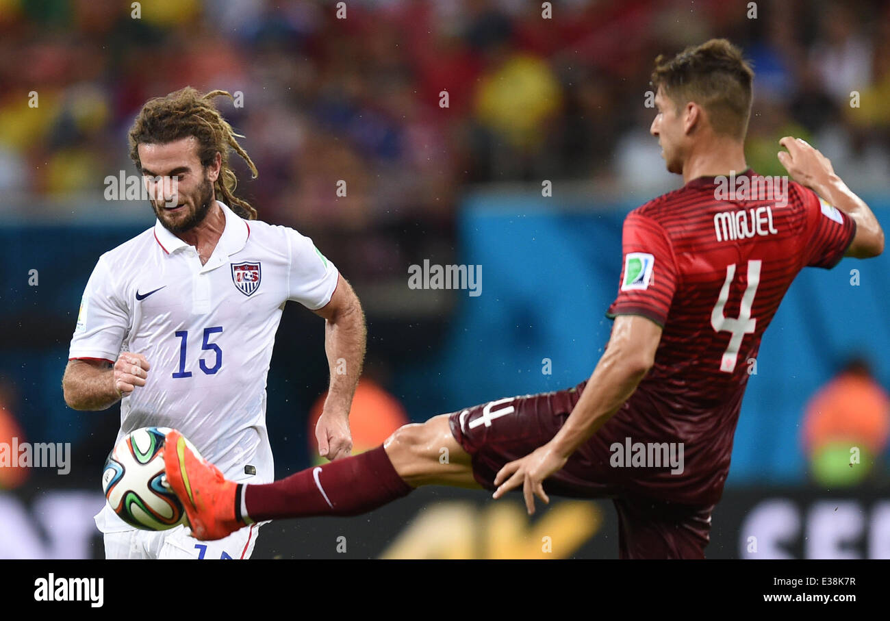 Manaus, Brazil. 22nd June, 2014. Kyle Beckerman of USA in action against Miguel Veloso (R) of Portugal during the FIFA World Cup 2014 group G preliminary round match between the USA and Portugal at the Arena Amazonia Stadium in Manaus, Brazil, 22 June 2014. Photo: Marius Becker/dpa/Alamy Live News Stock Photo