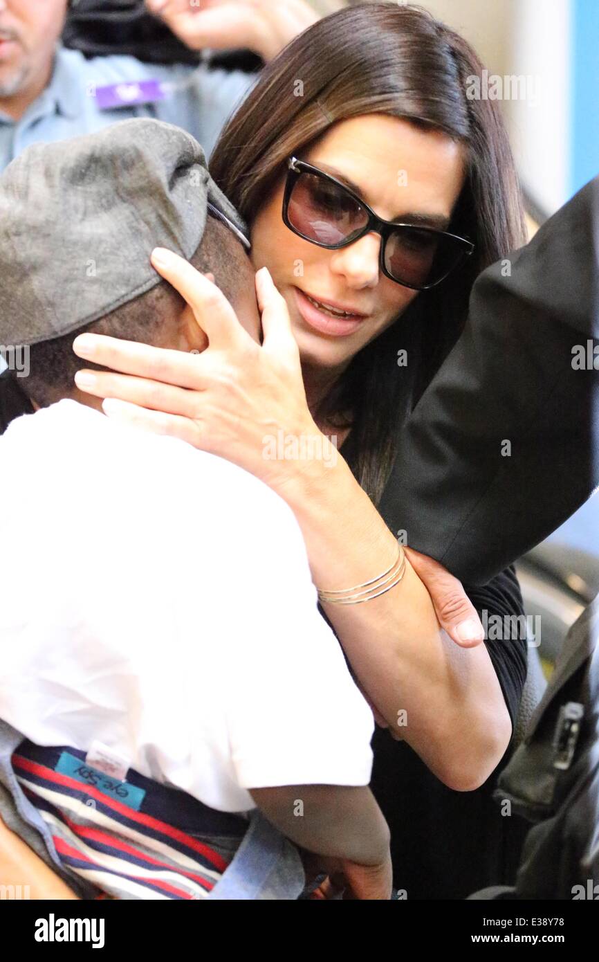 Sandra Bullock, along with her son Louis and a bodyguard, arrive at LAX