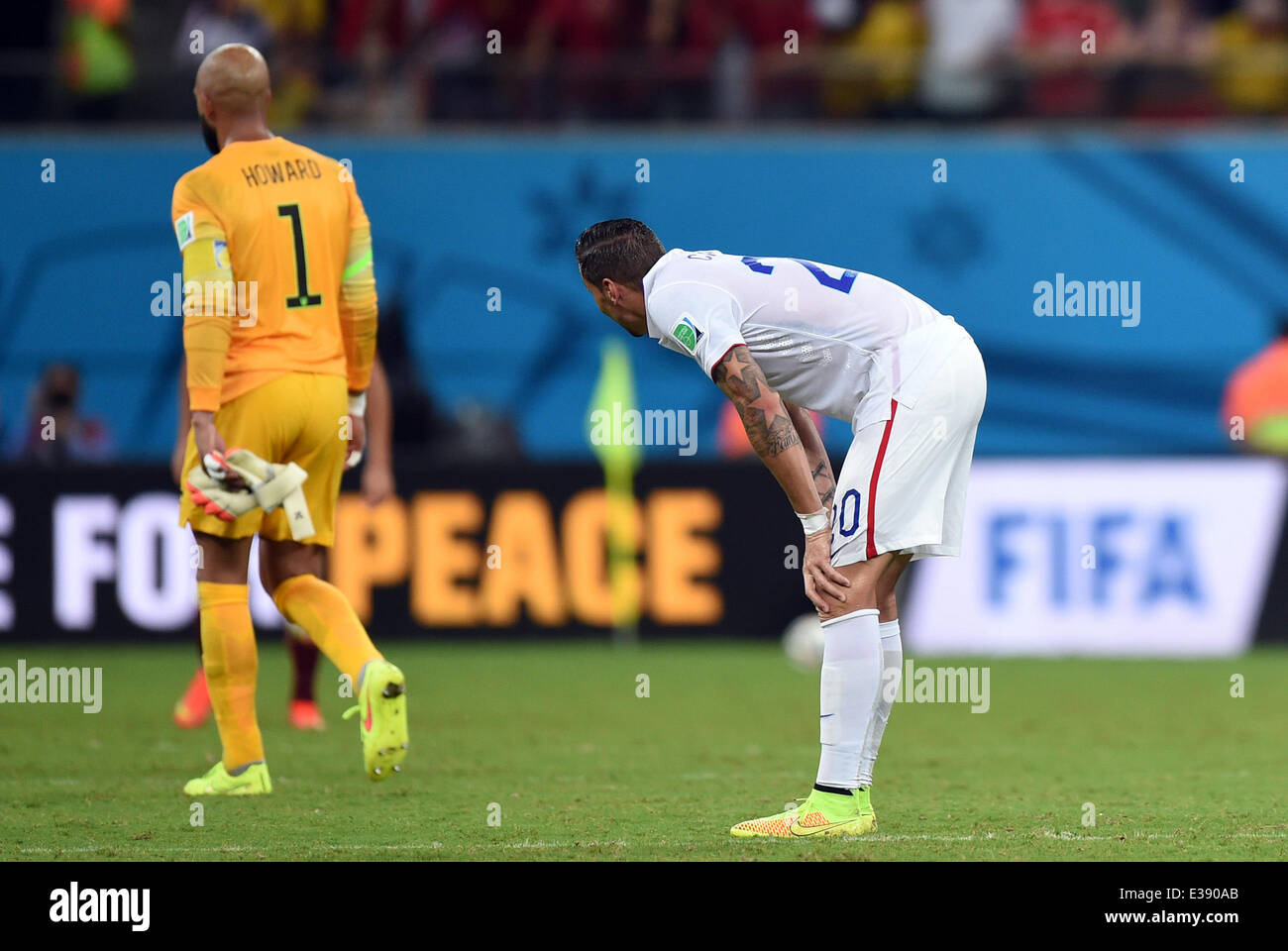 Manaus, Brazil. 22nd June, 2014. Goalkeeper Tim Howard (L) of USA leaves the pitch after the FIFA World Cup 2014 group G preliminary round match between the USA and Portugal at the Arena Amazonia Stadium in Manaus, Brazil, 22 June 2014. Photo: Marius Becker/dpa/Alamy Live News Stock Photo