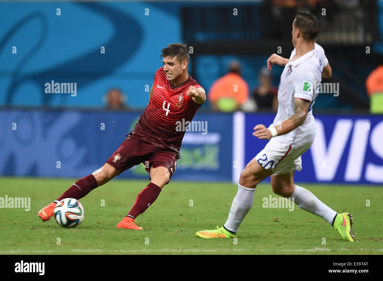Manaus, Brazil. 22nd June, 2014. Miguel Veloso (L) of Portugal in action against Geoff Cameron of USA during the FIFA World Cup 2014 group G preliminary round match between the USA and Portugal at the Arena Amazonia Stadium in Manaus, Brazil, 22 June 2014. Photo: Marius Becker/dpa/Alamy Live News Stock Photo