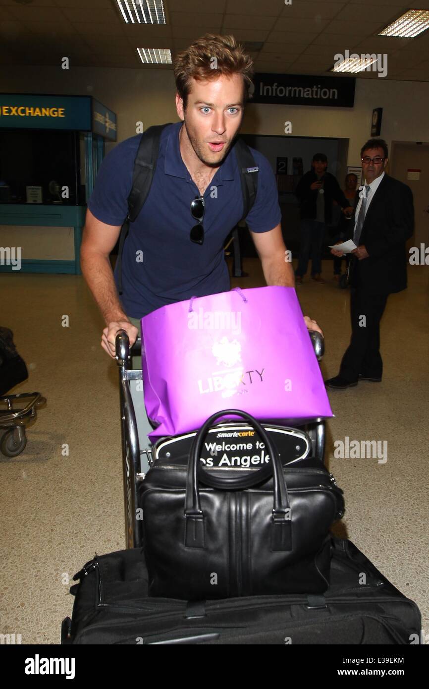 Armie Hammer and Elizabeth Chambers arrive at LAX, Los Angeles International Airport, on an Air New Zealand flight from London  Featuring: Armie Hammer Where: Los Angeles, CA, United States When: 29 Aug 2013 Stock Photo