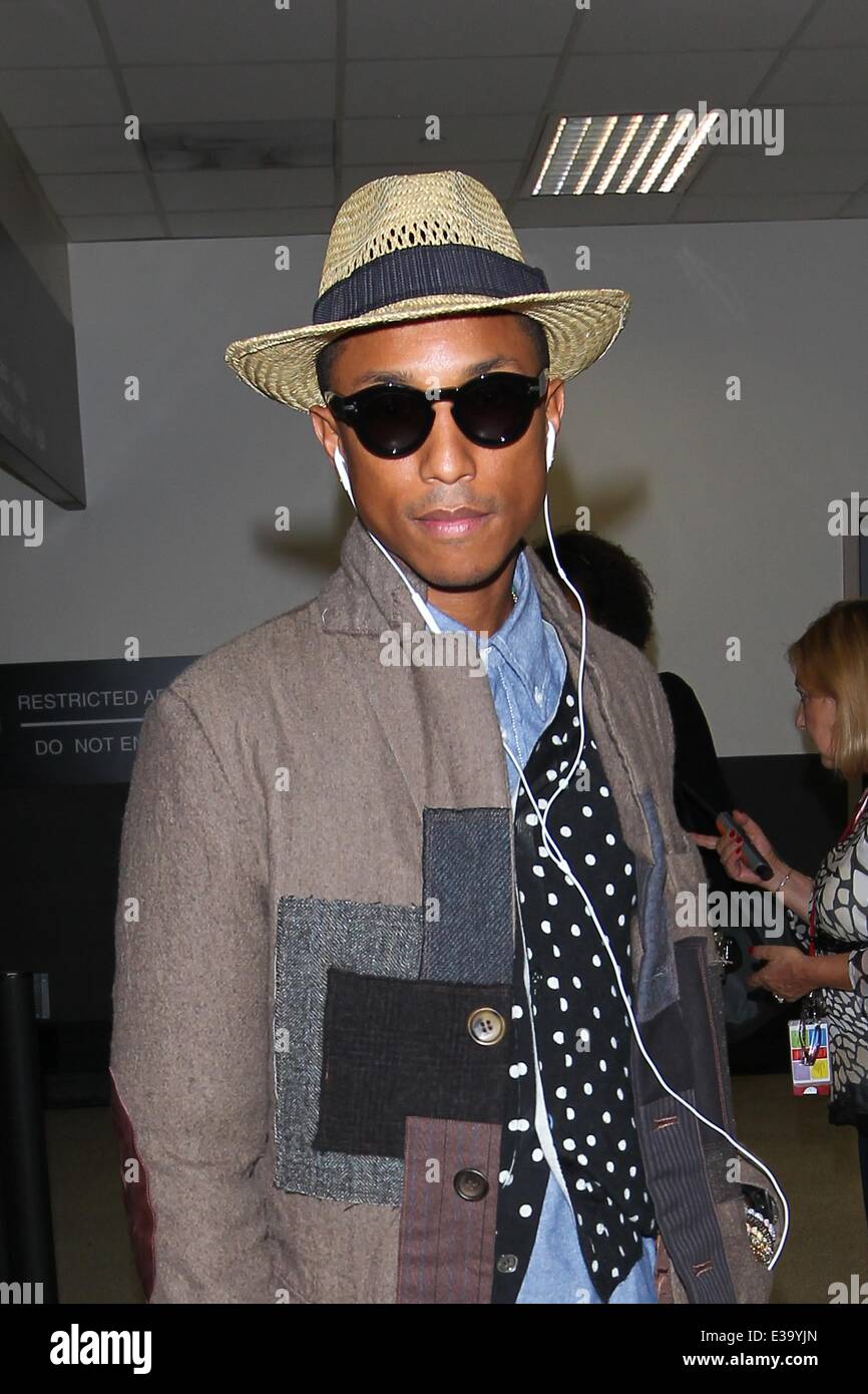 Pharrell Williams arrives at LAX in style. He wore a patchwork coat  complimented by a polka dot waistcoat with long tailed denim Stock Photo -  Alamy