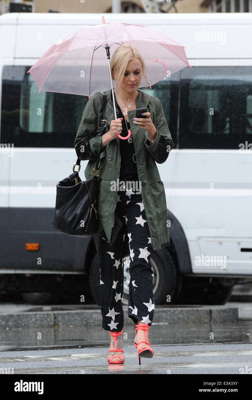 Fearne Cotton seen leaving the BBC Radio 1 studios on a wet friday afternoon, taking cover under her pink umbrella and using her phone  Featuring: Fearne Cotton Where: London, United Kingdom When: 06 Sep 2013 Stock Photo