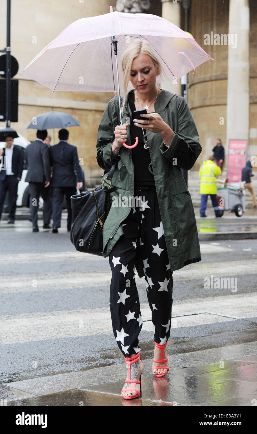 Fearne Cotton seen leaving the BBC Radio 1 studios on a wet friday afternoon, taking cover under her pink umbrella and using her phone  Featuring: Fearne Cotton Where: London, United Kingdom When: 06 Sep 2013 Stock Photo