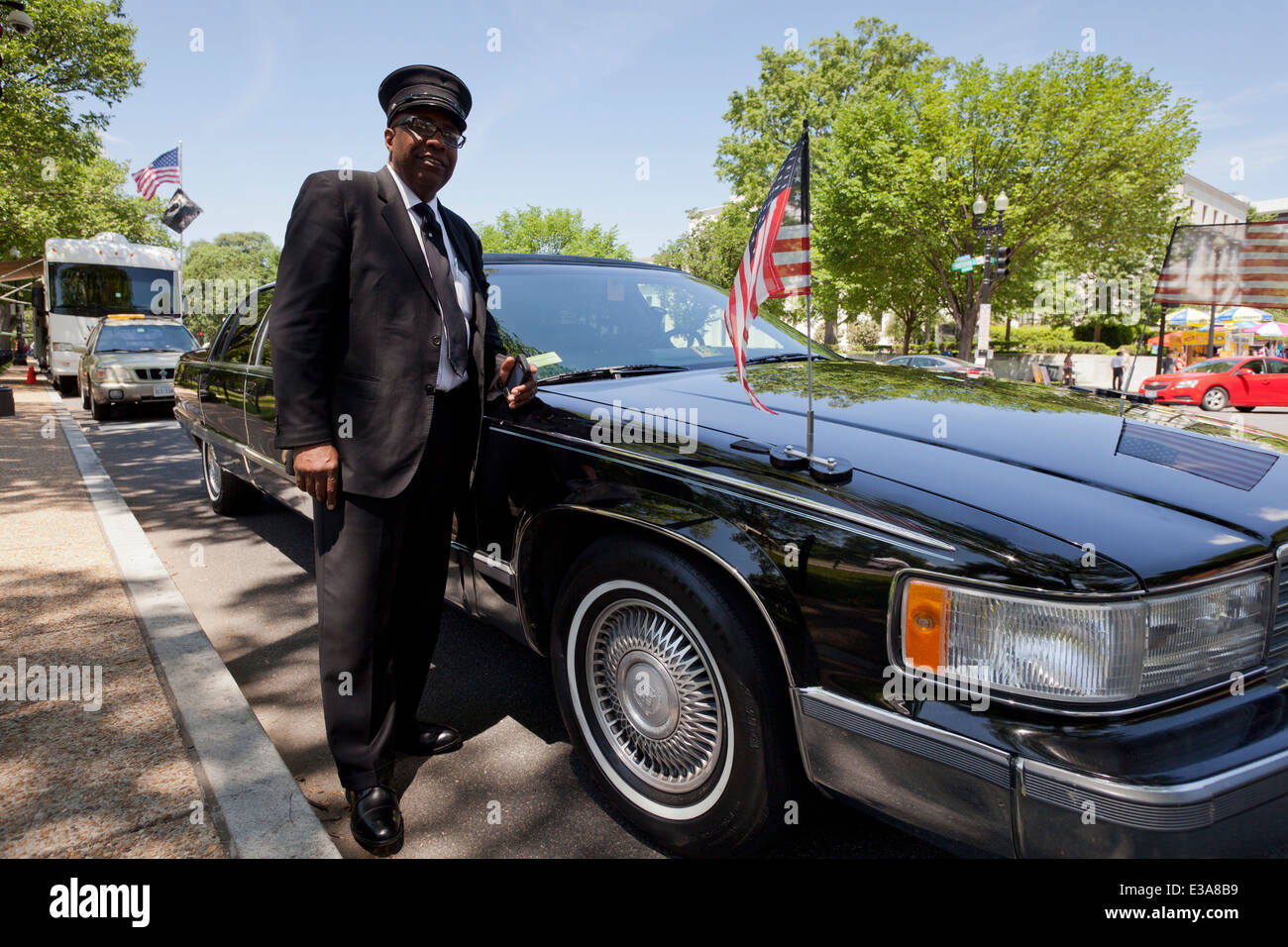 AfricanAmerican limousine driver standing next to car Washington