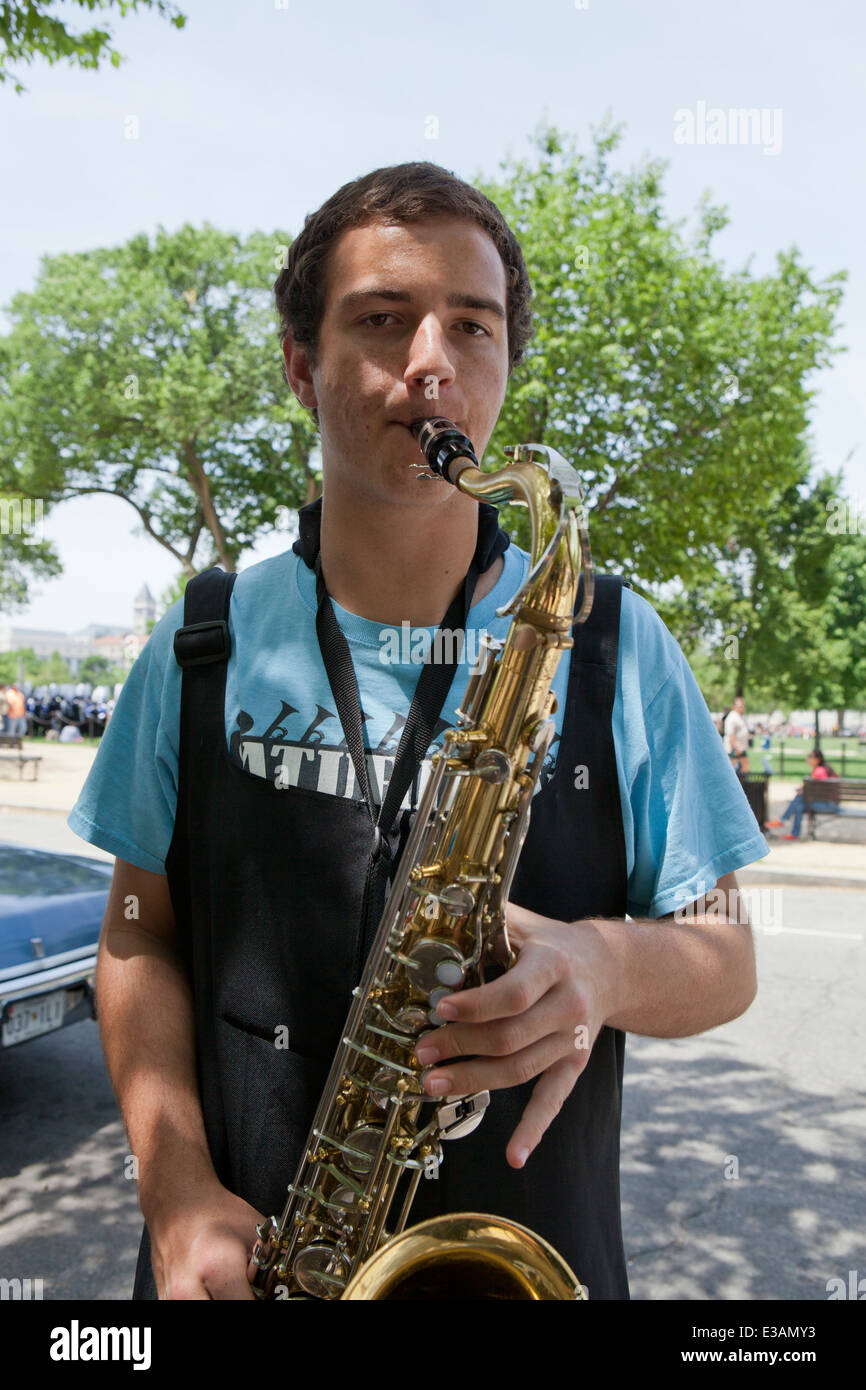 Young Caucasian saxophone player practicing for performance - USA Stock Photo