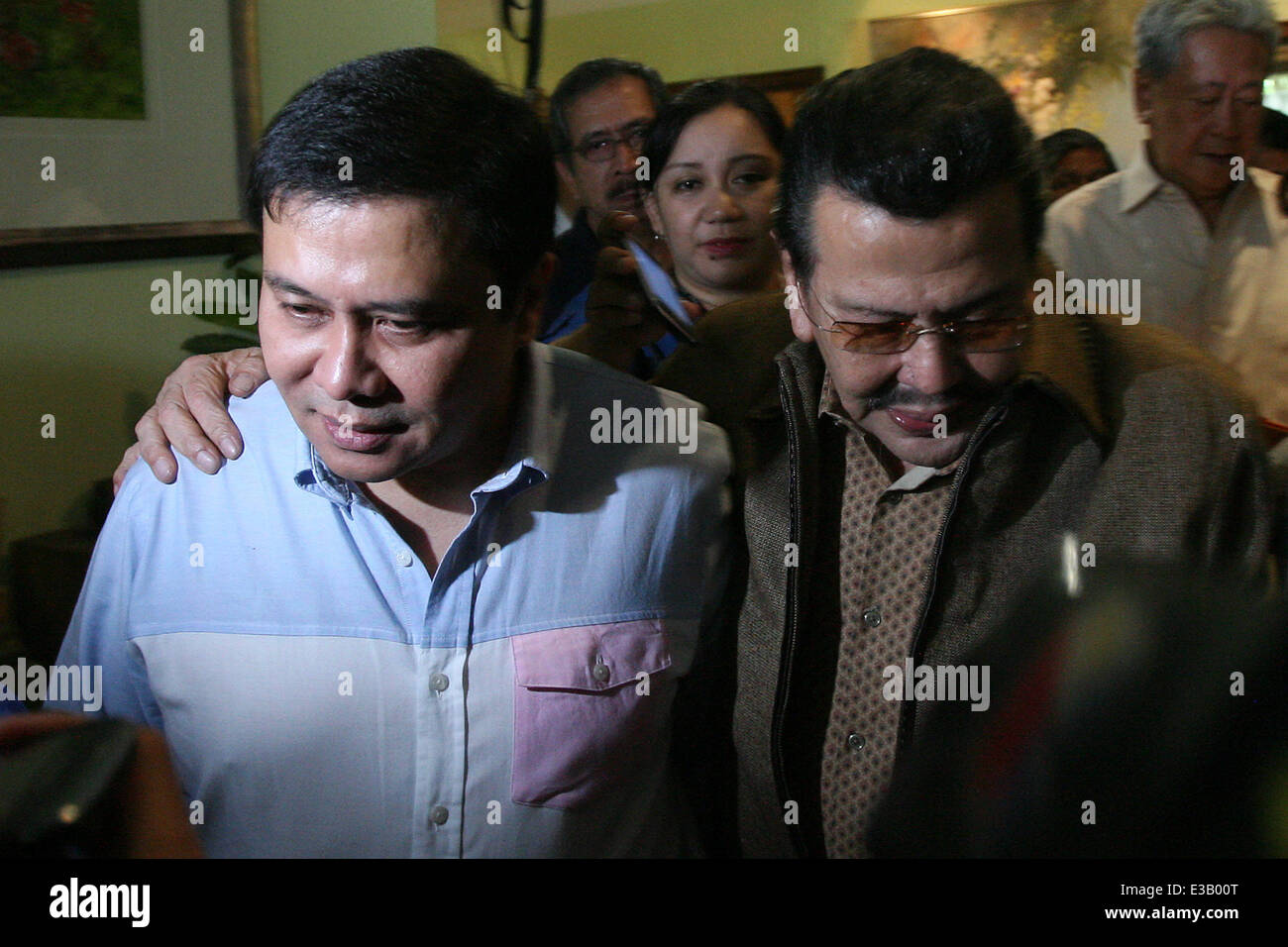 (140623) -- SAN JUAN CITY, June 23, 2014 (Xinhua) -- Philippine Senator Jinggoy Estrada (L) walks with his father, former President and current Mayor of Manila Joseph Estrada (R), at their home in San Juan City, the Philippines, June 23, 2014. Jinggoy Estrada surrendered to the Philippine anti-graft court to face plunder charges for the misuse of government funds. (Xinhua/Rouelle Umali) Stock Photo