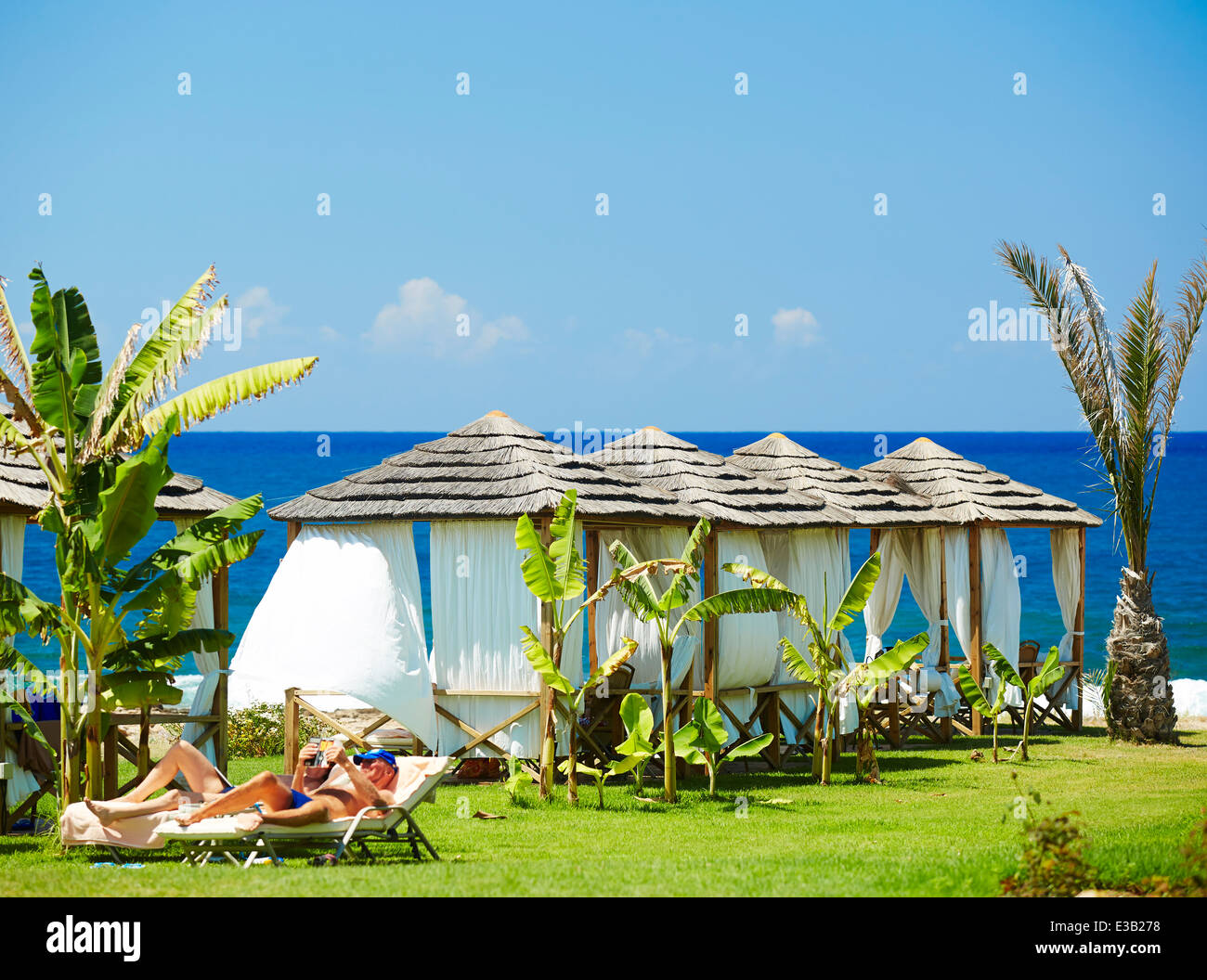Couple sunbathing on holiday Stock Photo