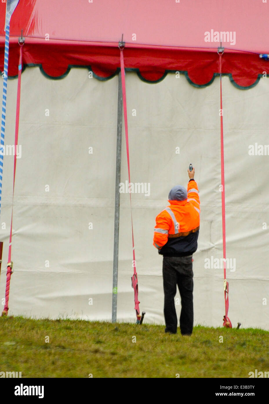Due to further winds forecast for the United Kingdom. Workmen re-enforce the arena tents at the Festival Number 6.  Where: Portmeirion, Wales When: 15 Sep 2013 Stock Photo