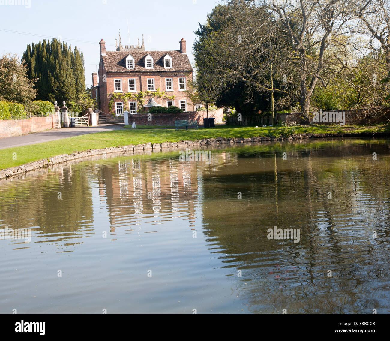 Large village duck pond and historic houses at Urchfont, Wiltshire