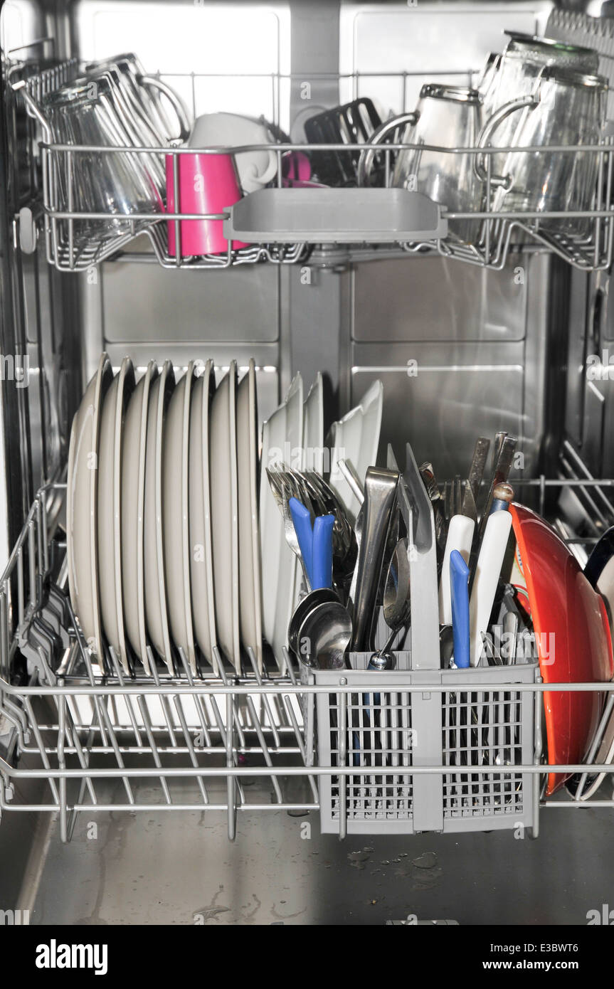Dishwasher stacked with dishes Stock Photo