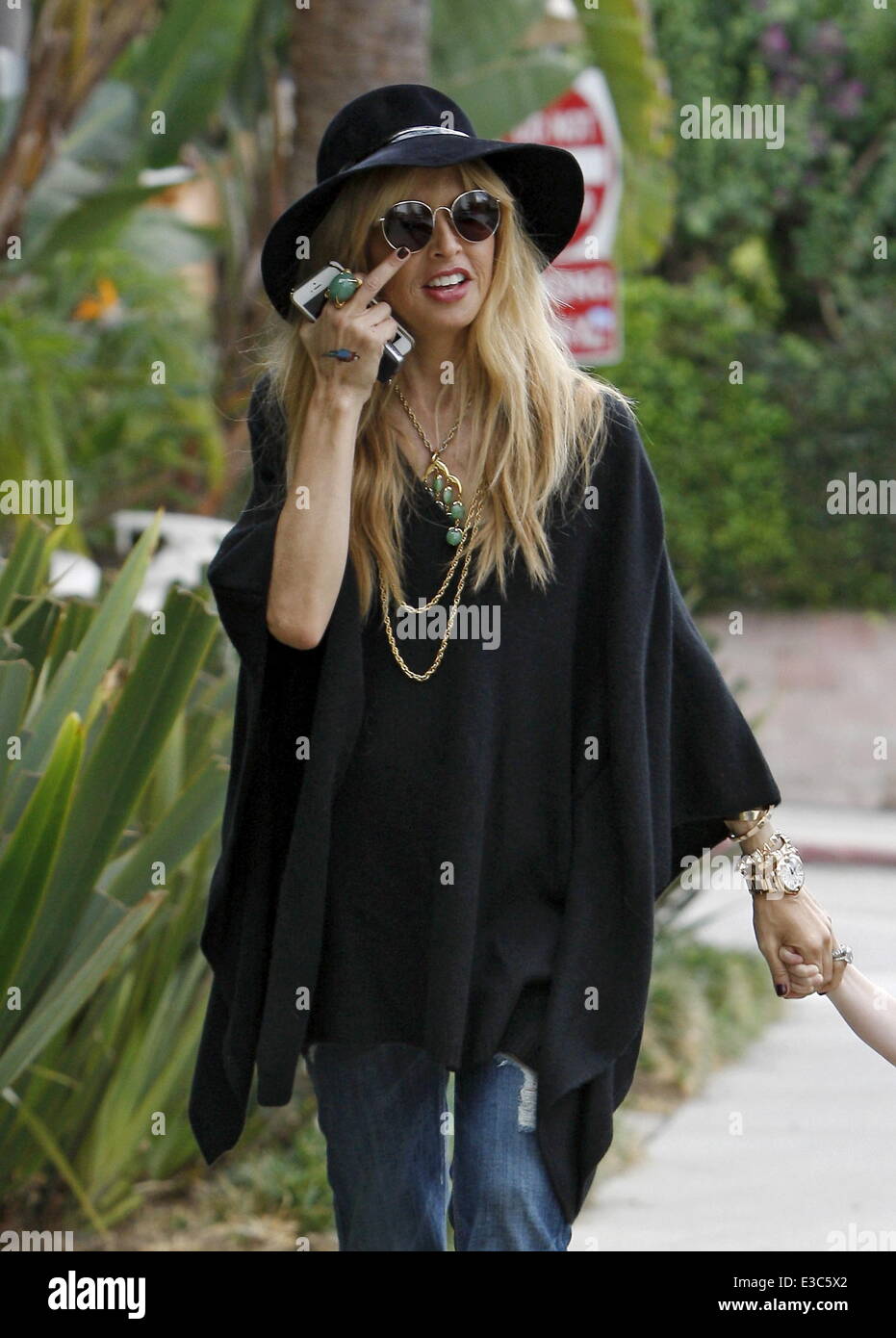 Rachel Zoe wearing flared jeans, out and about with her son Skyler in