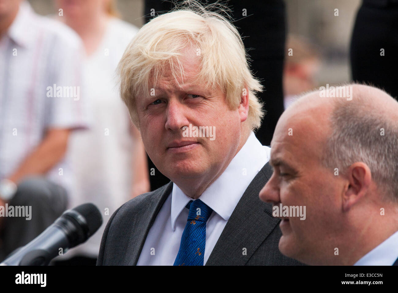 London, UK. 23rd June, 2014. Mayor of London Boris Johnson listens as Roger Evans, Chairman of the London Assembly addresses members and veterans of the armed forces as they gather at City Hall for a flag raising ceremony to mark Armed Forces Day Credit:  Paul Davey/Alamy Live News Stock Photo