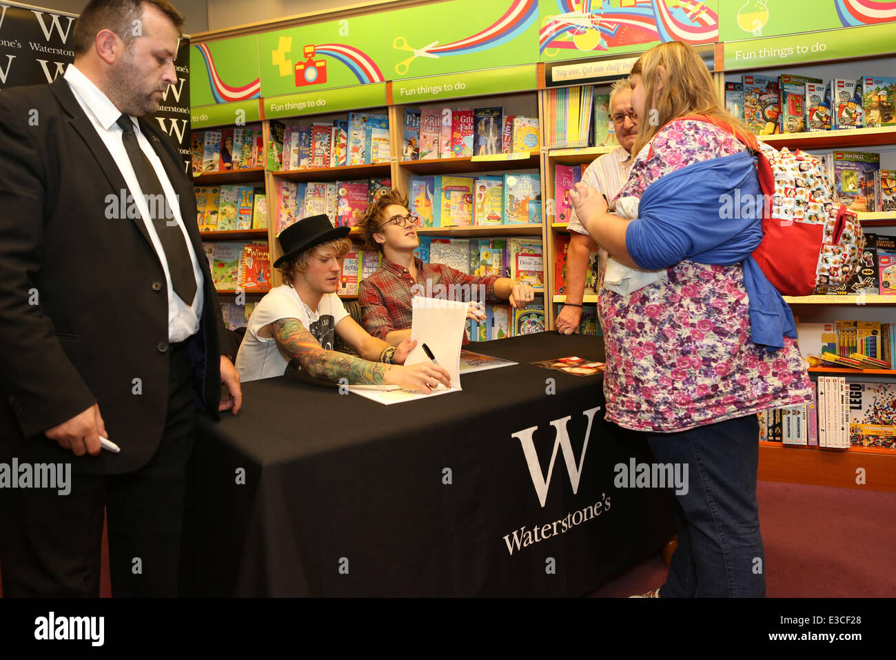 Dougie Poynter and Tom Fletcher, McFly Band members, sign copies of