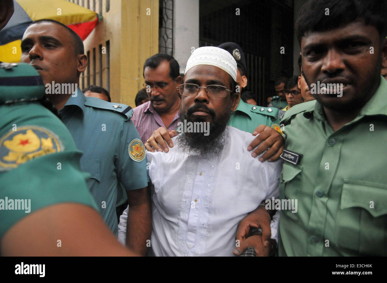 Dhaka, Bangladesh. 23rd June, 2014. A leader of Harkat-ul Jihad al Islami (in white) appears in court in Dhaka, Bangladesh, June 23, 2014. A court in Bangladesh's capital Dhaka on Monday awarded death penalty to eight militants of a banned Islamist outfit including its ringleader for bomb explosions at an open-air Bengali New Year concert in 2001 that left at least eight people killed and many more others injured. Credit:  Shariful Islam/Xinhua/Alamy Live News Stock Photo