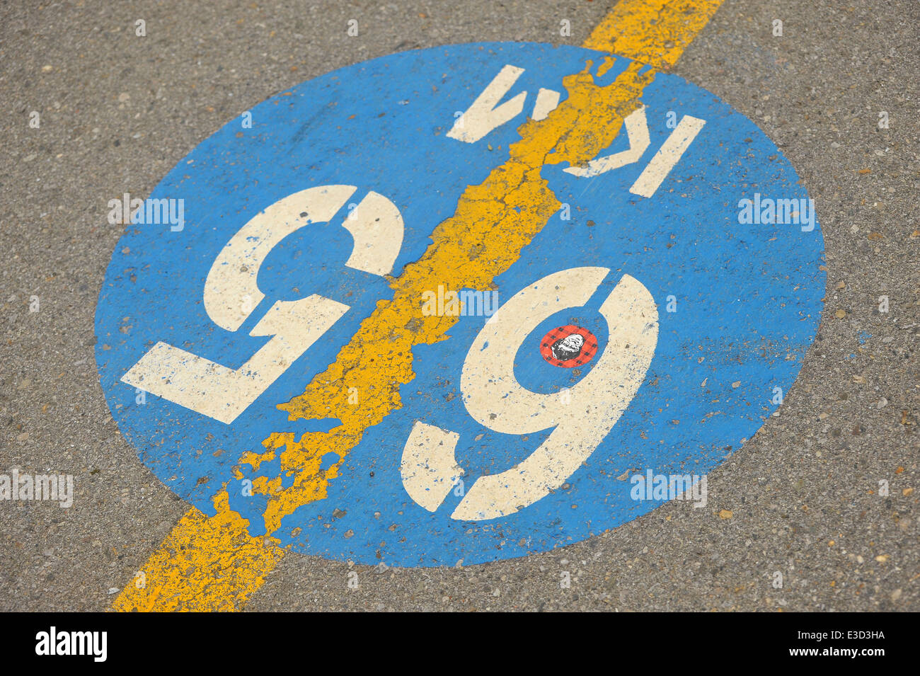 A distance marker sign painted on a cycle path in London, Ontario. Stock Photo