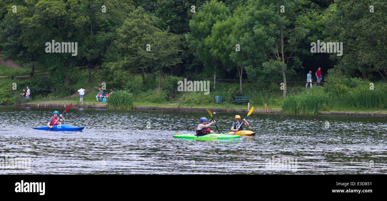 Children and instructors canoeing/kayaking  on the lake in Yarrow Valley Country Park, Coppull in Lancashire, UK. Stock Photo