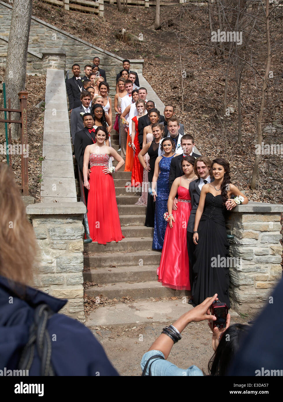 A group of high school students posing for their prom pictures at Minnehaha falls, Minneapolis, USA. Stock Photo