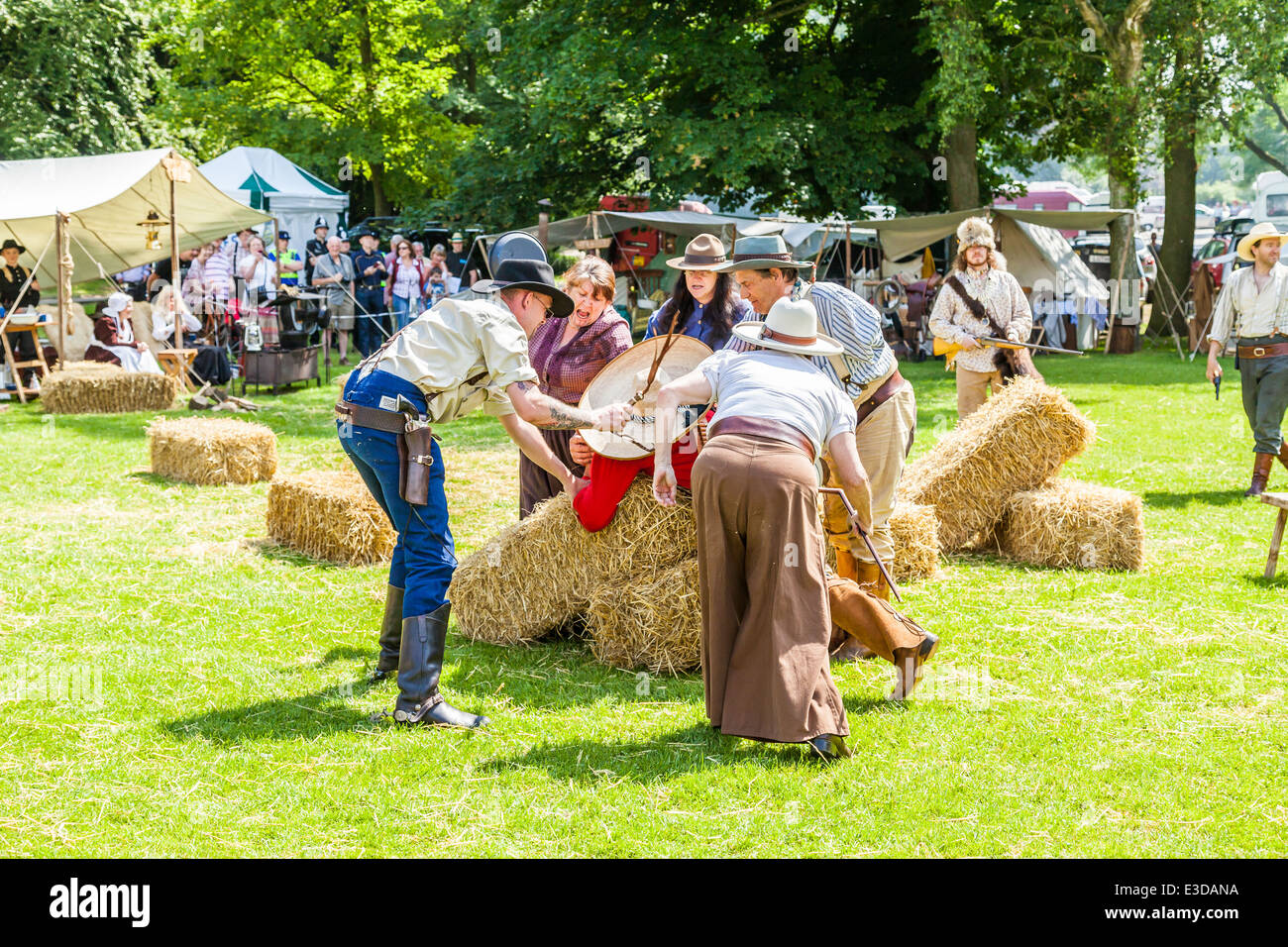 Leek, Staffordshire, England. 22nd June 2014, A Country and Western Weekend. A Lynch mob threaten to hang Villain Cowboy. Stock Photo