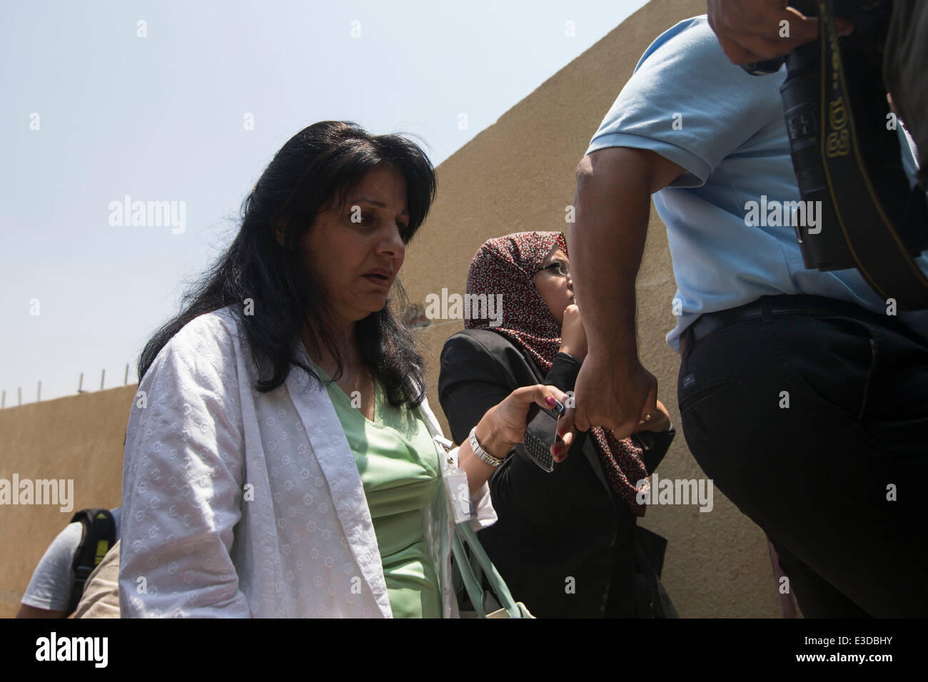 Cairo, Egypt. 23rd June, 2014. Wafa Bassiouni, mother of Egyptian-Canadian journalist Mohamed Fadel Fahmy, walks out of the court after the verdict in Cairo, June 23, 2014. An Egyptian court on Monday sentenced three Al-Jazeera journalists, Australian Peter Greste, Egyptian-Canadian Mohamed Fadel Fahmy and Egyptian producer Baher Mohamed, to seven years in jail over charges of aiding the outlawed Muslim Brotherhood. Credit:  Cui Xinyu/Xinhua/Alamy Live News Stock Photo