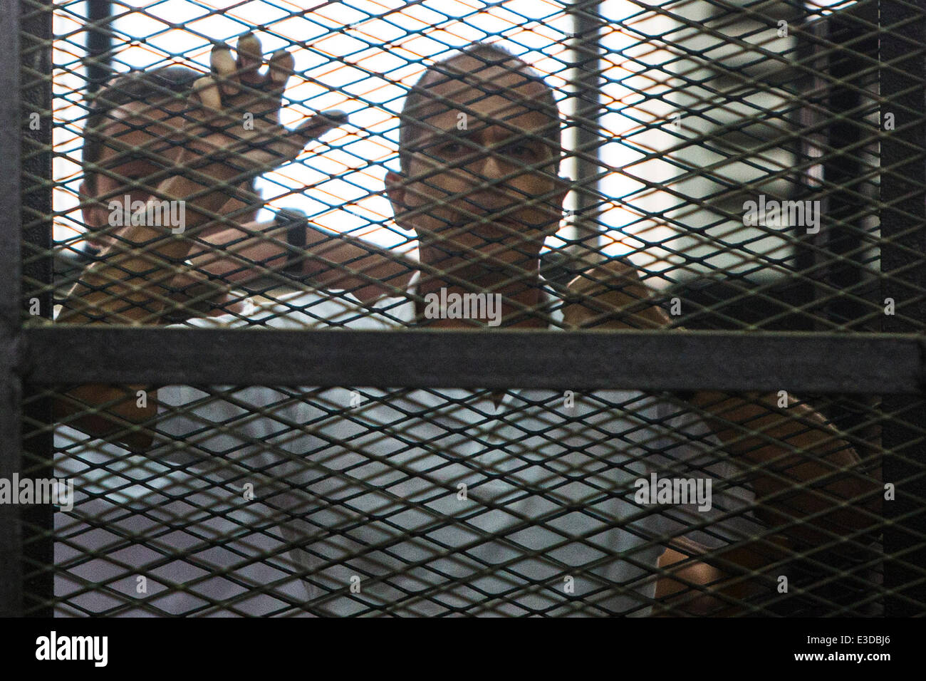 Cairo, Egypt. 23rd June, 2014. Al-Jazeera's Australian journalist Peter Greste stands behind bars as he listens to the verdict at a court in Cairo, June 23, 2014. An Egyptian court on Monday sentenced three Al-Jazeera journalists, Australian Peter Greste, Egyptian-Canadian Mohamed Fadel Fahmy and Egyptian producer Baher Mohamed, to seven years in jail over charges of aiding the outlawed Muslim Brotherhood. Credit:  Cui Xinyu/Xinhua/Alamy Live News Stock Photo