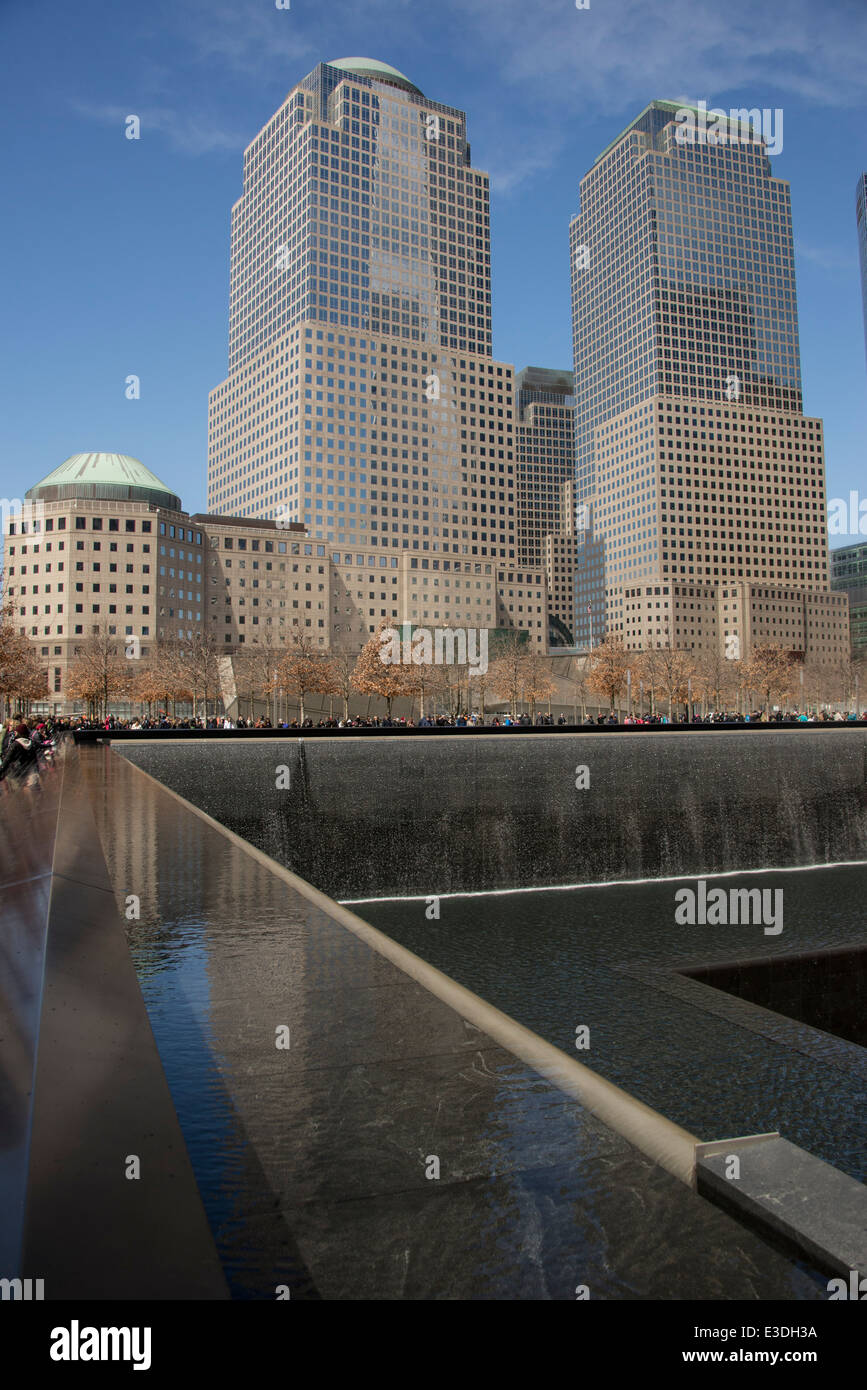 The National September 11 Memorial where the Twin Towers once stood with the new One World Trade Center just to the north Stock Photo