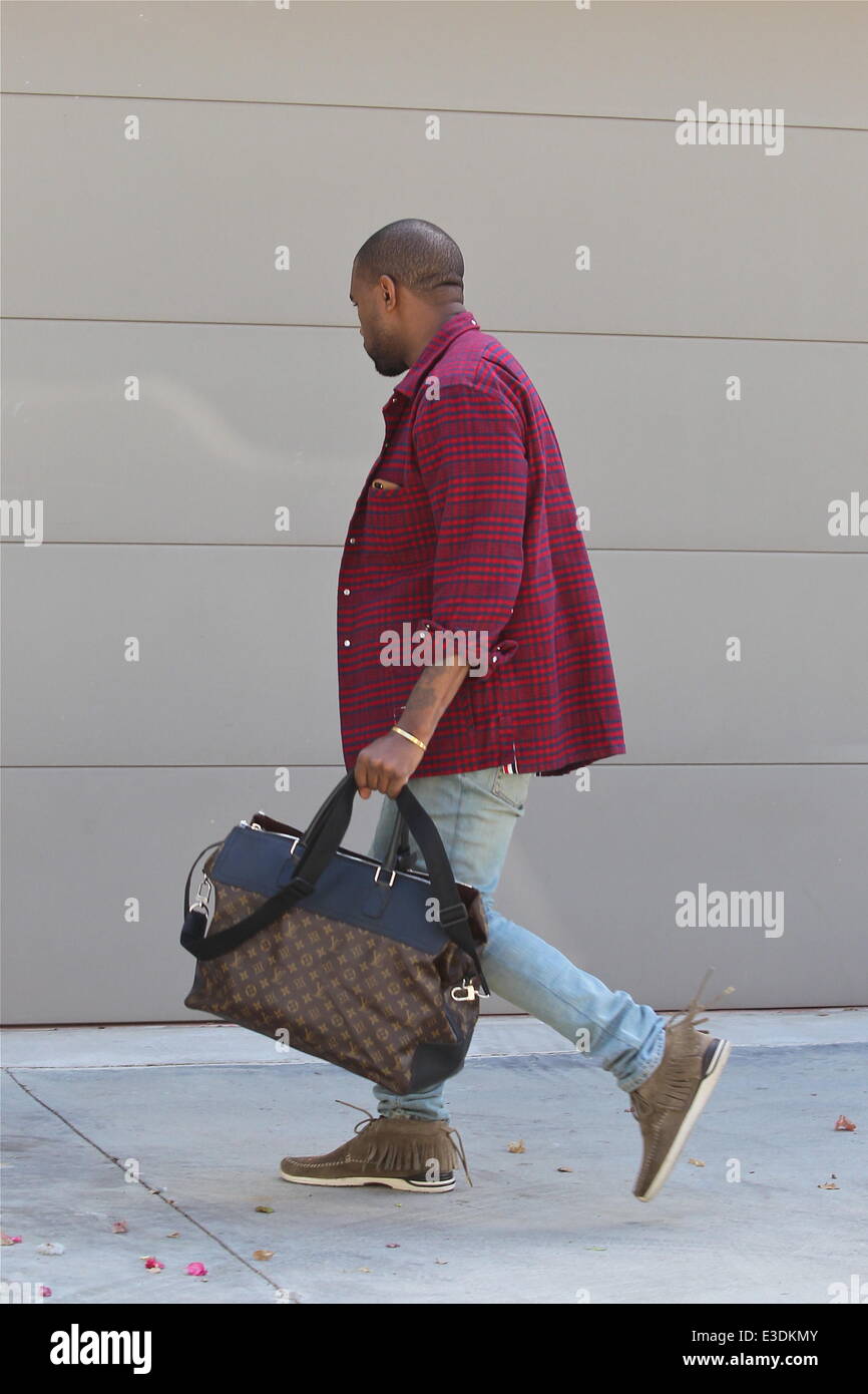 Kanye West leaving his office in a red and blue checkered jacket