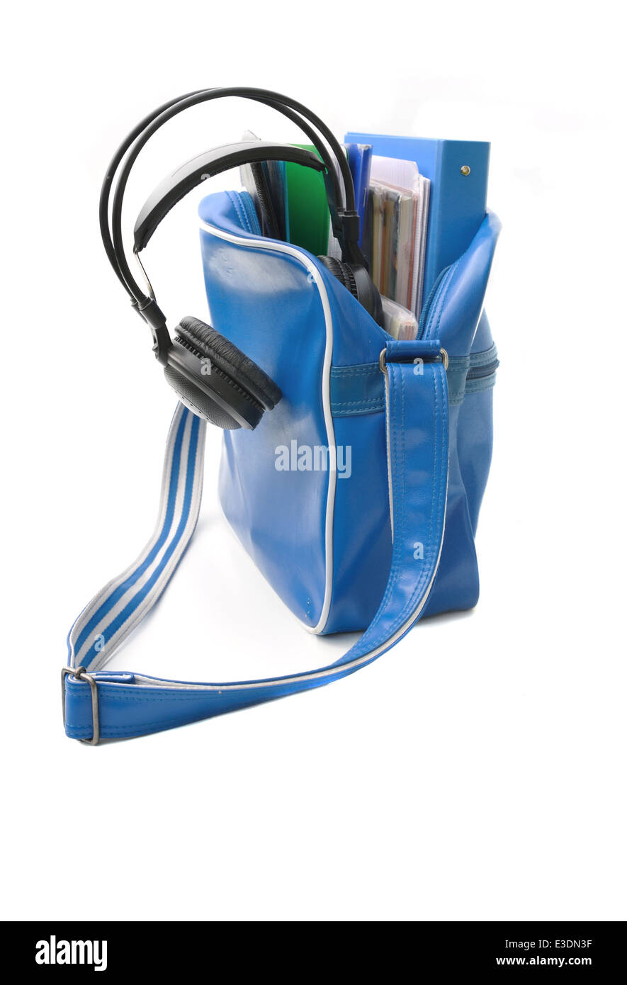 blue schoolbag of a teenager with headphones on white background Stock Photo
