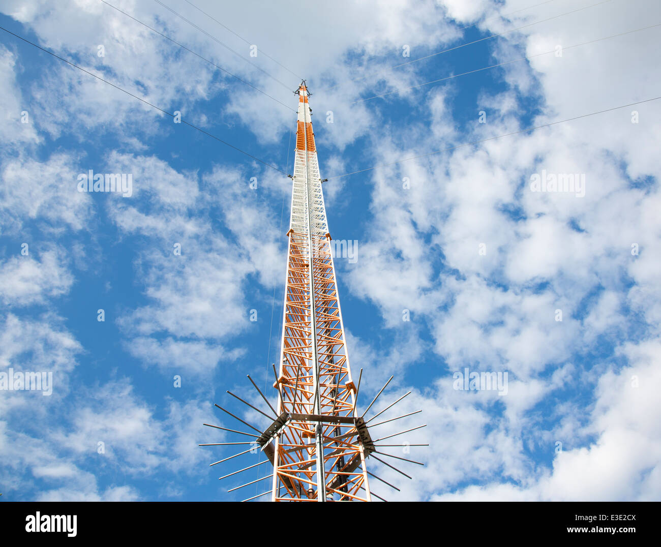 Metallic guyed telecommunications mast / tower containing cellular network antennas. Anti climb spikes at the bottom of the mast. , Finland Stock Photo