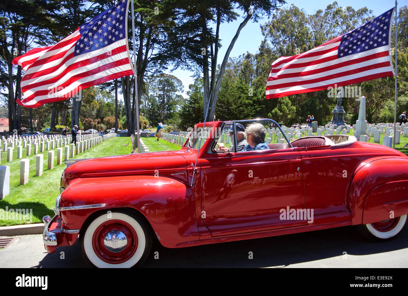 couple sitting in 1940s Plymouth convertible at car show in San Francisco Stock Photo