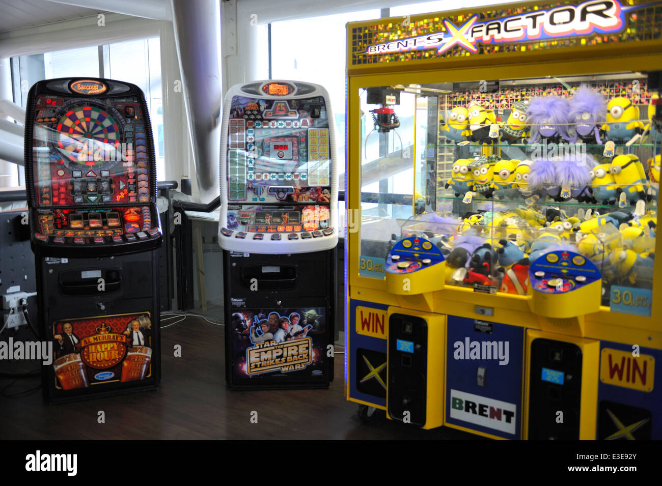 Arcade gambling slot machines and coin operated 'grabber' amusement machine at Bristol airport, UK Stock Photo